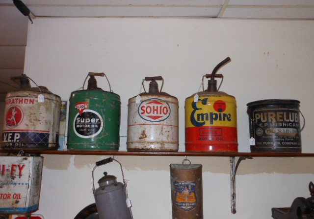 Shelves of vintage oil cans including Polly, Gulf and Penn brands