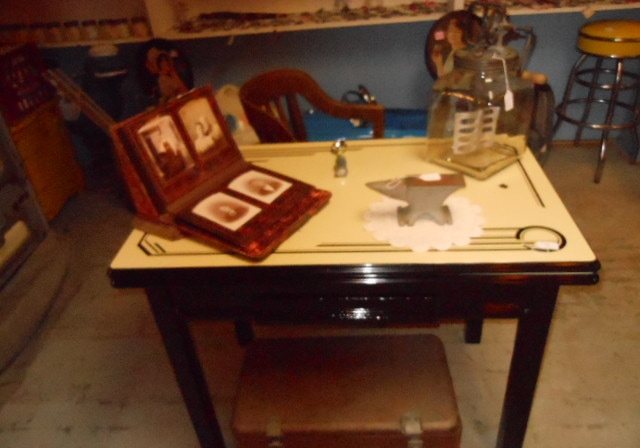 An antique table with advertising items and small collectibles on it