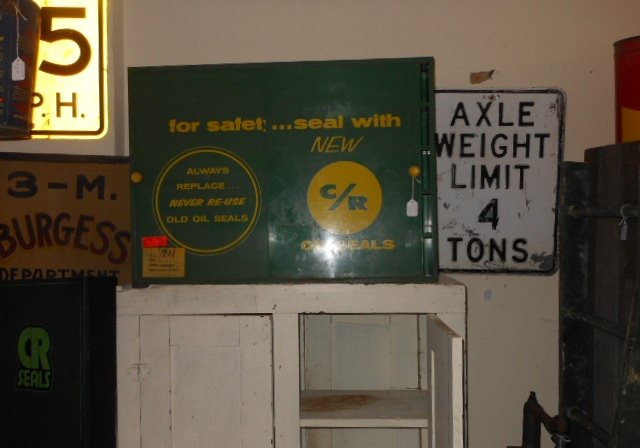Vintage metal road signs including a five miles per hour sign and an axle weight limit sign
