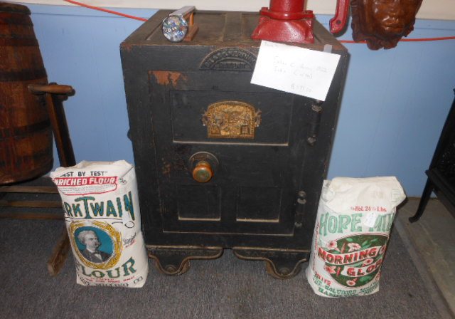 A black cast iron floor safe with gold pinstriping