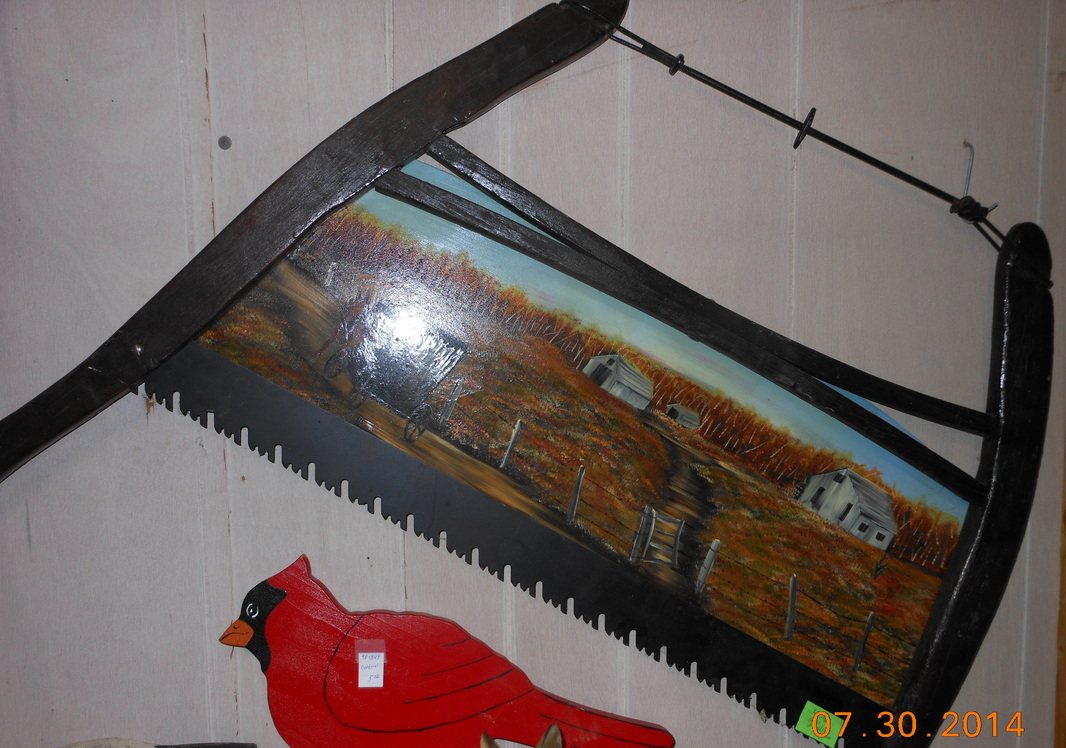 A hand painted saw blade with a cardinal on it