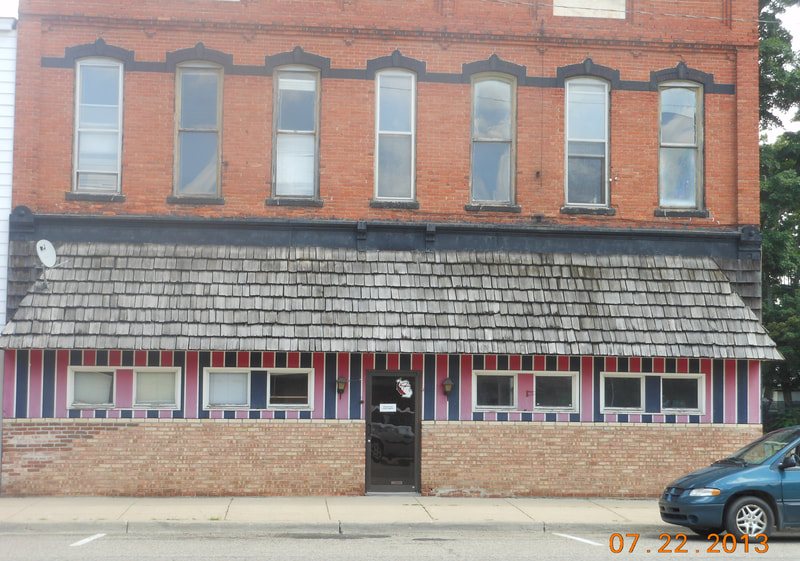 The brick storefront of 66 Unique Antiques on Main Street