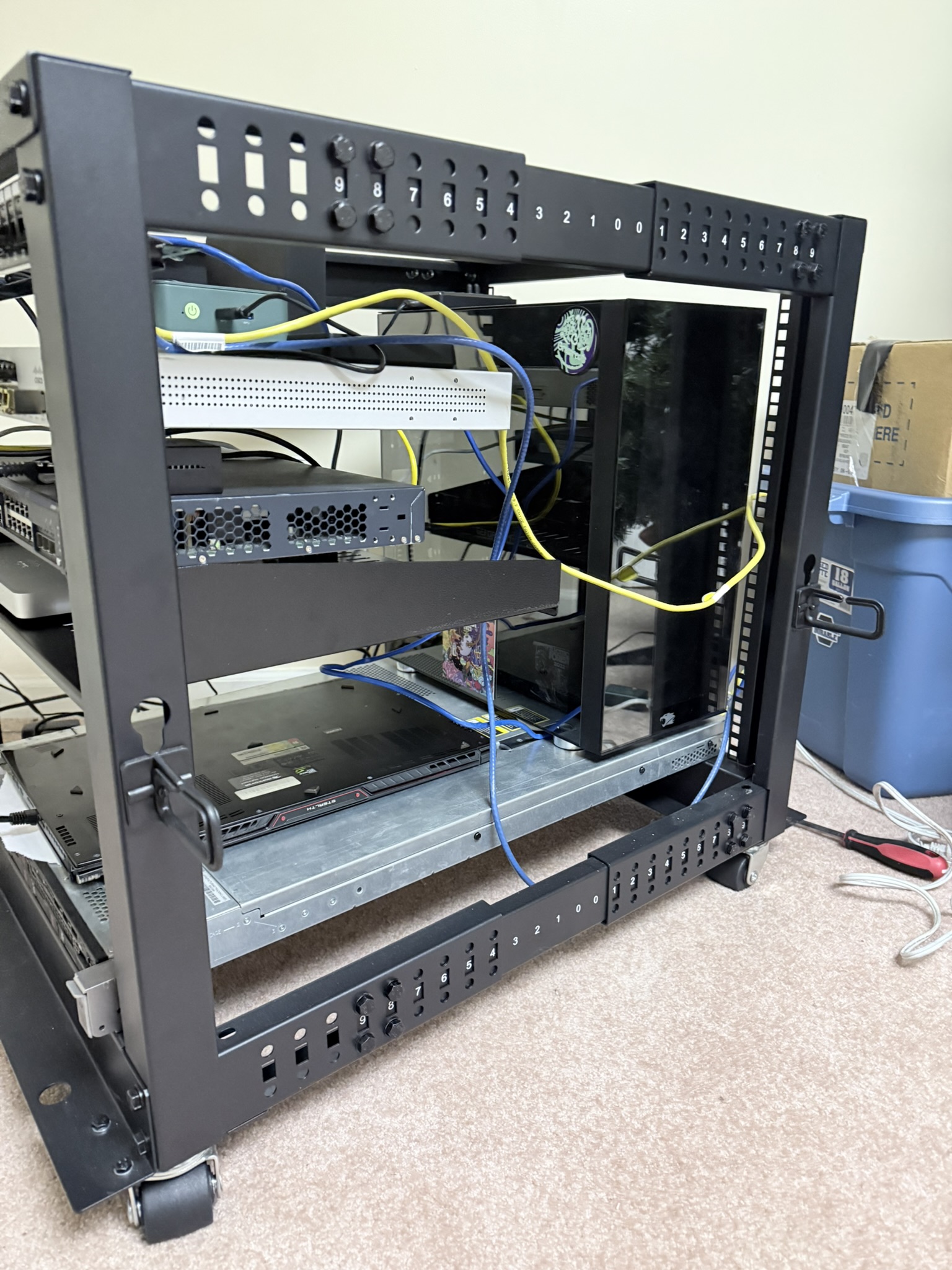 The physical stack. An open-frame rack, scavenged and upgraded over years.